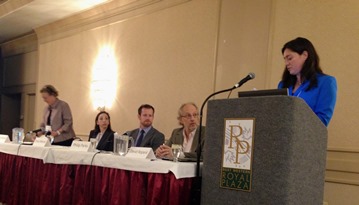 The afternoon plenary panelists are introduced by Robyn Alie.